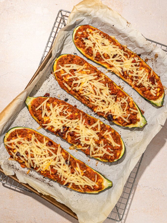stuffed zucchini halves on baking sheet